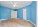 Spacious light blue bedroom with hardwood floors and ample closet space at 115 Wilkins Rd, Fayetteville, GA 30214