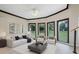 Spacious living room with hardwood floors, bay windows, and modern furniture at 115 Wilkins Rd, Fayetteville, GA 30214
