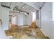 Unfinished basement with concrete floors and exposed beams at 115 Wilkins Rd, Fayetteville, GA 30214