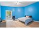 Blue bedroom with hardwood floors, a bed, and a ceiling fan at 115 Wilkins Rd, Fayetteville, GA 30214