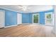 Blue bedroom with hardwood floors and access to a deck at 115 Wilkins Rd, Fayetteville, GA 30214