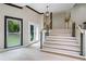 Bright entryway with hardwood floors and a modern staircase at 115 Wilkins Rd, Fayetteville, GA 30214