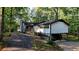 White ranch house with attached garage and wooded lot at 5475 Chapel Hill Rd, Douglasville, GA 30135