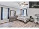 Well-lit bedroom with a queen bed, dresser, and ample space at 2225 Pleasant Hill Rd, Atlanta, GA 30349