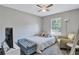 Comfortable bedroom with a queen-size bed, sitting chair, and a large window at 2225 Pleasant Hill Rd, Atlanta, GA 30349