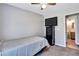 Well-lit bedroom with a twin-size bed and ensuite bathroom access at 2225 Pleasant Hill Rd, Atlanta, GA 30349