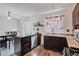 Eat-in kitchen with island, stainless steel dishwasher, and dark wood cabinets at 2225 Pleasant Hill Rd, Atlanta, GA 30349
