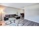 Open concept living room with L-shaped sofa and dining area at 2225 Pleasant Hill Rd, Atlanta, GA 30349