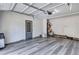 Garage with gray walls, vinyl flooring, and an exterior door at 2225 Pleasant Hill Rd, Atlanta, GA 30349
