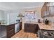 L-shaped kitchen with stainless steel appliances and dark wood cabinets at 2225 Pleasant Hill Rd, Atlanta, GA 30349