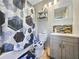 Updated bathroom with a shower/tub combo, modern vanity, and stylish hexagon-patterned shower curtain at 2225 Pleasant Hill Rd, Atlanta, GA 30349