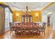 Formal dining room with hardwood floors and a large wooden table at 1565 Mountain Shadow Trl, Stone Mountain, GA 30087