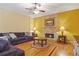 Living room with fireplace, hardwood floors, and ceiling fan at 1565 Mountain Shadow Trl, Stone Mountain, GA 30087