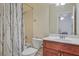Clean bathroom with tub shower combo and wood vanity at 1565 Mountain Shadow Trl, Stone Mountain, GA 30087