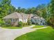 Brick house with landscaped yard, driveway, and large trees at 1565 Mountain Shadow Trl, Stone Mountain, GA 30087
