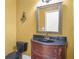 Powder room with dark vanity, granite countertop, and framed mirror at 1565 Mountain Shadow Trl, Stone Mountain, GA 30087