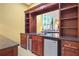 Wet bar with granite countertop, mini fridge, and shelving at 1565 Mountain Shadow Trl, Stone Mountain, GA 30087