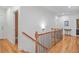 Upstairs hall with hardwood floors and elegant staircase at 1565 Mountain Shadow Trl, Stone Mountain, GA 30087
