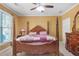 Bedroom with a large four poster bed, ceiling fan and dresser at 1565 Mountain Shadow Trl, Stone Mountain, GA 30087