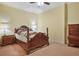 Traditional bedroom with wooden furniture and carpeted floor at 1565 Mountain Shadow Trl, Stone Mountain, GA 30087