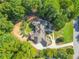 Luxury home nestled on a wooded lot with a large driveway at 1565 Mountain Shadow Trl, Stone Mountain, GA 30087