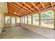 Bright screened porch featuring wood ceiling and backyard access at 139 Old Mill Sw Trl, Conyers, GA 30094