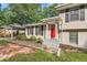 Ranch style home with red front door and landscaped yard at 139 Old Mill Sw Trl, Conyers, GA 30094