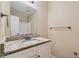 Bathroom boasts granite countertop, white vanity, and a large mirror at 139 Old Mill Sw Trl, Conyers, GA 30094