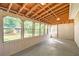 Spacious screened porch with concrete floor and view of backyard at 139 Old Mill Sw Trl, Conyers, GA 30094