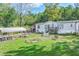 Mobile home with carport and small landscaped yard at 4310 Bryan Se Ln, Acworth, GA 30102