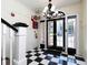 Bright entryway with black and white checkered floor and chandelier at 242 12Th Ne St # 8, Atlanta, GA 30309