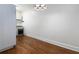 Modern white kitchen featuring stainless steel appliances and hardwood floors at 242 12Th Ne St # 8, Atlanta, GA 30309
