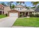 Brick two-story home with a two-car garage and landscaped lawn at 465 Roland Manor Dr, Dacula, GA 30019