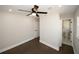 Bright bedroom with dark hardwood floors, ceiling fan and private bath at 662 Gary Nw Rd, Atlanta, GA 30318