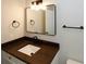 Bathroom with dark vanity and rectangular mirror at 662 Gary Nw Rd, Atlanta, GA 30318