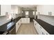 Renovated kitchen featuring white cabinets, dark countertops, and subway tile backsplash at 662 Gary Nw Rd, Atlanta, GA 30318