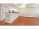 Open living area with hardwood floors and kitchen bar at 230 E Ponce De Leon Ave # 314, Decatur, GA 30030