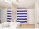 Clean bathroom with a shower/tub combo and striped shower curtain at 230 E Ponce De Leon Ave # 314, Decatur, GA 30030