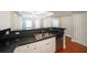 Modern kitchen features white cabinets, dark countertops, and stainless steel appliances at 230 E Ponce De Leon Ave # 314, Decatur, GA 30030
