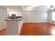 Open living room with hardwood floors and kitchen bar at 230 E Ponce De Leon Ave # 314, Decatur, GA 30030