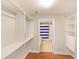 Large walk-in closet with built-in shelving and drawers at 230 E Ponce De Leon Ave # 314, Decatur, GA 30030