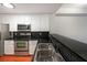 Modern kitchen with stainless steel appliances and granite countertops at 230 E Ponce De Leon Ave # 314, Decatur, GA 30030