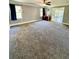 Large living room with carpet and access to back porch at 2735 Sandy Creek Cir, Loganville, GA 30052