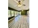 Sunroom featuring light wood flooring and green walls at 2735 Sandy Creek Cir, Loganville, GA 30052