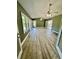 Sunroom with green walls, wood-look flooring, and French doors at 2735 Sandy Creek Cir, Loganville, GA 30052
