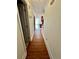 Long hallway with wood floors leading to kitchen at 2735 Sandy Creek Cir, Loganville, GA 30052