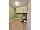 Clean laundry room with built-in cabinets and tile floor at 2735 Sandy Creek Cir, Loganville, GA 30052
