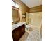 Bathroom with tub, shower, and wood vanity at 2735 Sandy Creek Cir, Loganville, GA 30052