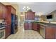 Spacious kitchen with dark wood cabinets, granite countertops, and stainless steel appliances at 2607 Marleigh Farm Nw Rd, Kennesaw, GA 30152