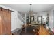 Open concept dining room with hardwood floors and barn door at 1688 Richland Sw Rd, Atlanta, GA 30311